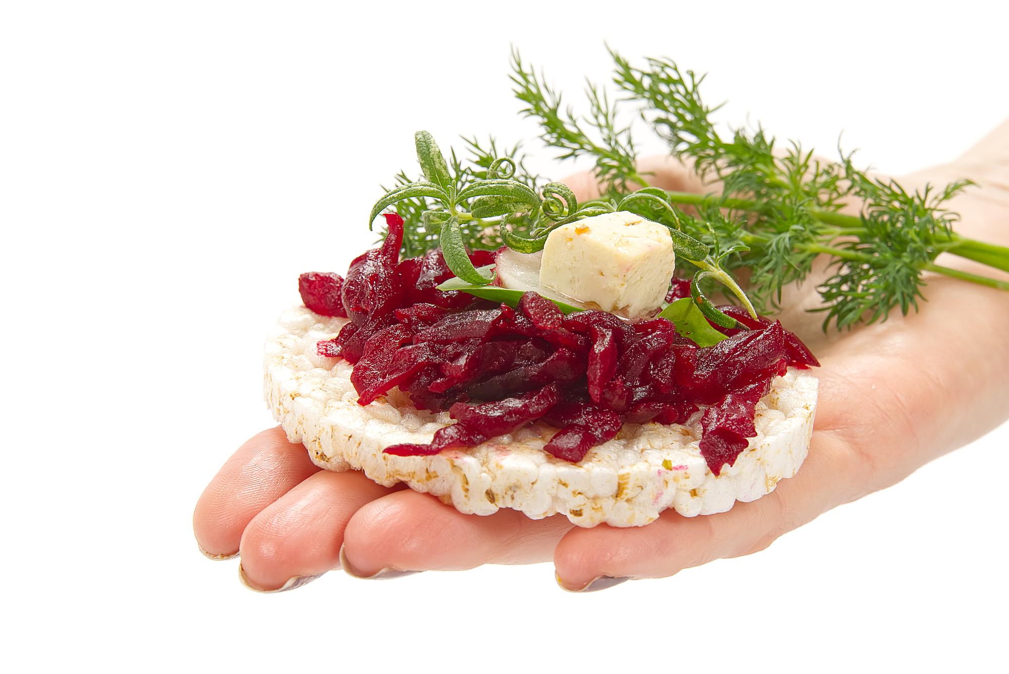 Close-up of hands garnishing a dish
